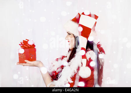 Jeune femme en costume père noël holding gift box Banque D'Images