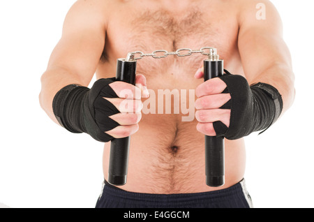 Arts martiaux fighter holding nunchucks noir avec ses mains Banque D'Images