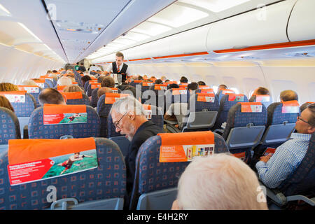 Steward servant de passagers en vol à bord d'un avion Easyjet. Banque D'Images