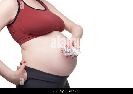 Pregnant woman holding pills Banque D'Images