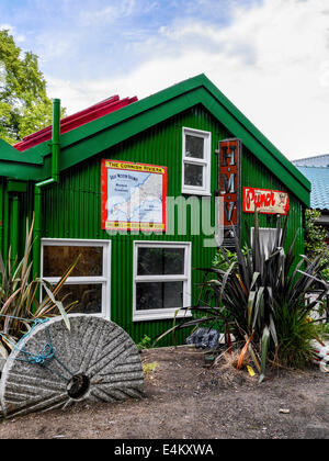 Lion Boathouse, Eel Pie Island, Twickenham, Greater London, UK - un bâtiment en fer ondulé vert avec de vieilles annonces Banque D'Images