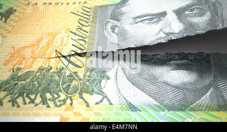 Un concept photo d'un Australian one hundred dollar note déchirer dans deux façons de longueur sur un fond isolé Banque D'Images