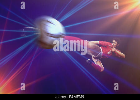 Soccer Player Kicking the ball in Mid-Air Banque D'Images