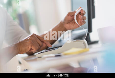 Close up of man's hands using calculator Banque D'Images