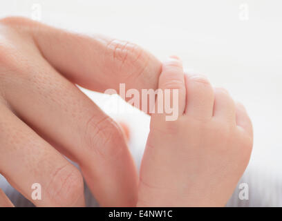 Close up of mother's hand touching Baby Boy's (2-5 mois) foot Banque D'Images
