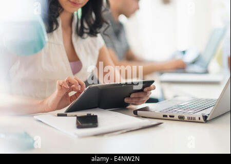 Close up of young woman and man working in office Banque D'Images