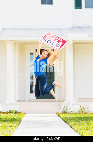 USA, Floride, Jupiter, femme de sauter devant un nouvelle maison Banque D'Images