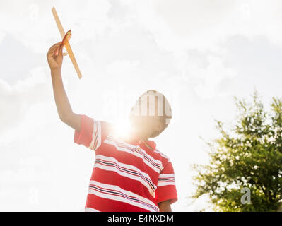 Boy (6-7) Playing with toy airplane Banque D'Images