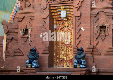 Jimbaran, Bali, Indonésie. Hindu Temple Guardian portant Saput Poleng, un tissu à carreaux noirs et blancs. Banque D'Images