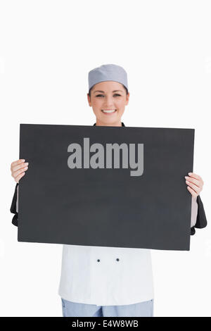 Smiling chef holding blackboard Banque D'Images