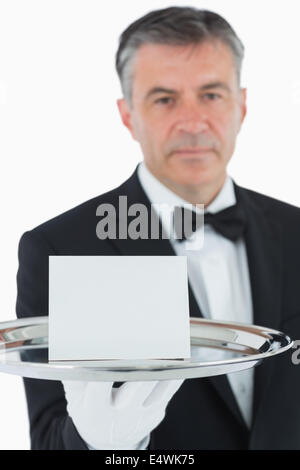 Man holding silver tray avec carte blanche Banque D'Images