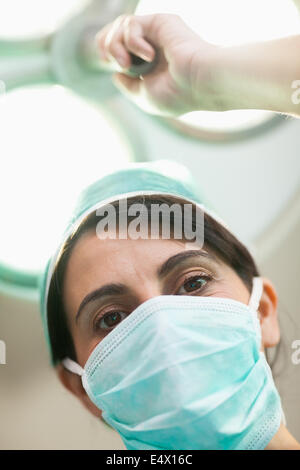 Femme tenant un chirurgien d'éclairage chirurgical Banque D'Images