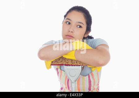 Bored woman leaning on a mop Banque D'Images