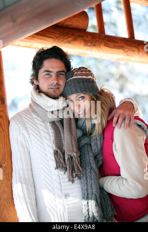 A couple hugging on patio chalet Banque D'Images