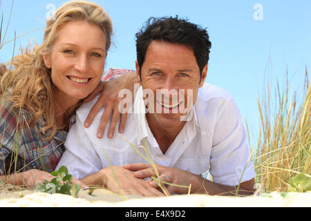 Couple allongé sur le sable. Banque D'Images