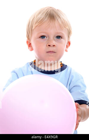 Young boy holding ball Banque D'Images