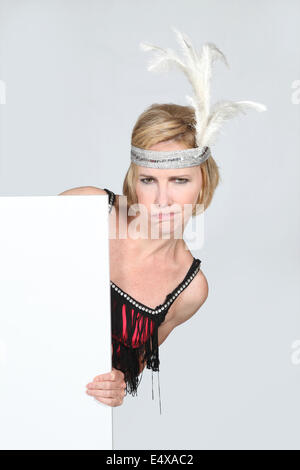 Woman in party dress holding marketing board Banque D'Images