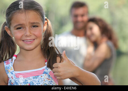 Little girl giving thumbs-up geste Banque D'Images