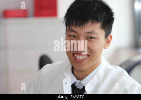 Smiling Asian man in a lab coat Banque D'Images