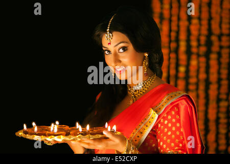 Portrait of a woman holding a tray de diyas Banque D'Images