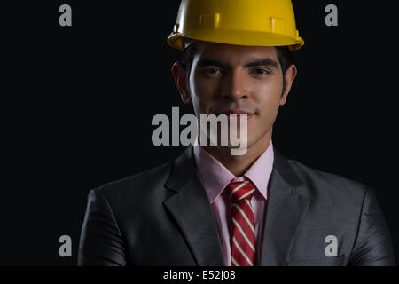 Portrait of male architect wearing hardhat sur fond noir Banque D'Images
