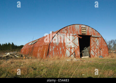 Barn rouge rusty abandonné dans le champ près de Glasgow Banque D'Images