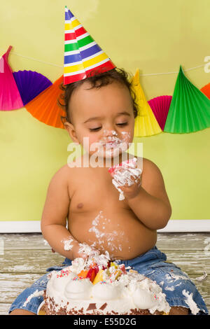 Adorable bébé africain lors d'un smash de gâteau sur son premier anniversaire Banque D'Images