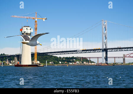 Une vue sur le ponts traversant le Firth of Forth en Écosse. Le pilier de l'avant-plan est une base pour le nouveau passage. Banque D'Images