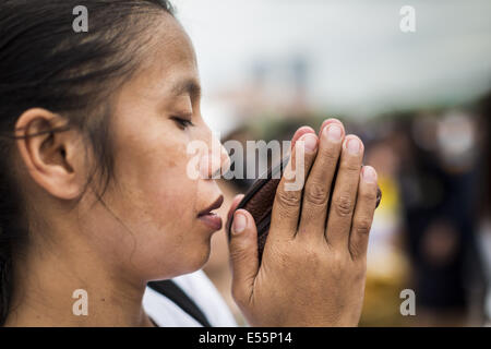 Bangkok, Thaïlande. 22 juillet, 2014.Une femme thaïlandaise prie lors d'une cérémonie qui mérite à Sanam Luang. Des centaines de militaires thaïlandais officiers et fonctionnaires ont assisté à un service de chants bouddhistes et le mérite de faire de la cérémonie pour marquer le 2ème mois anniversaire du 22 mai coup d'État qui a déposé le gouvernement civil élu et s'est terminé près de six mois, parfois violents, des manifestations anti-gouvernementales. Credit : ZUMA Press, Inc./Alamy Live News Banque D'Images