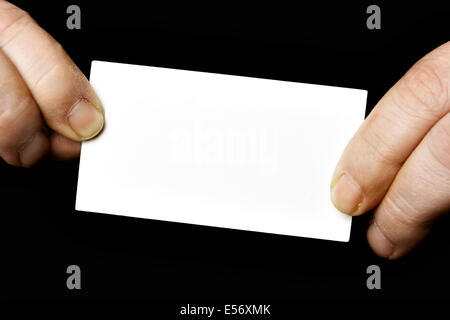 Blank business card en mains sur fond noir Banque D'Images