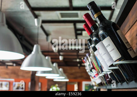 Trois bouteilles de vin en bois sur des étagères dans un restaurant. Banque D'Images