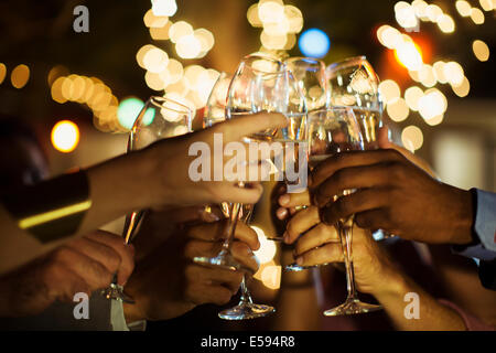 Friends toasting each other at party Banque D'Images