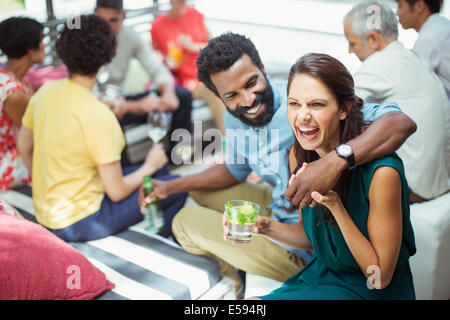 Couple hugging at party Banque D'Images