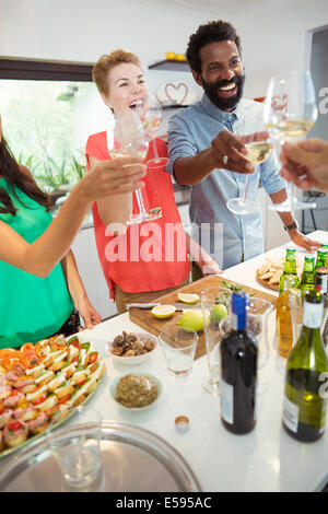 Friends toasting each other at party Banque D'Images