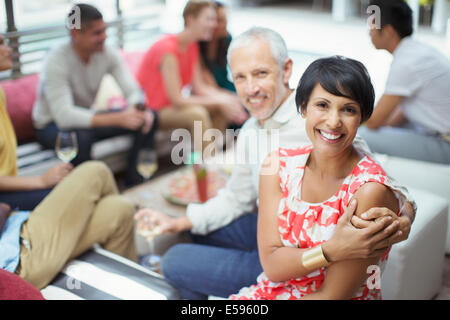 Couple hugging at party Banque D'Images