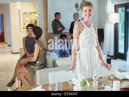 Woman smiling at table at party Banque D'Images