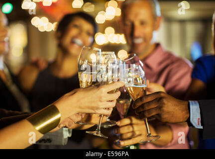 Friends toasting each other at party Banque D'Images