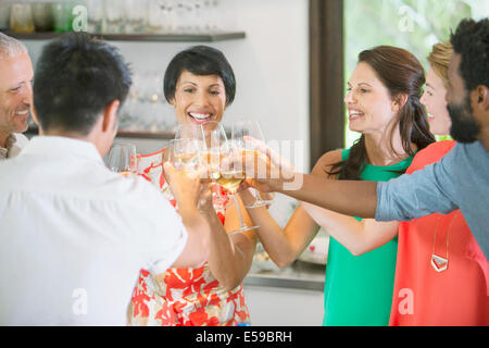 Friends toasting each other at party Banque D'Images