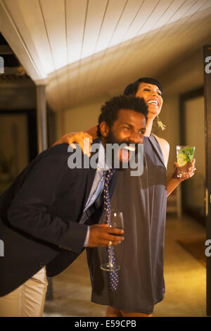 Couple laughing together at party Banque D'Images