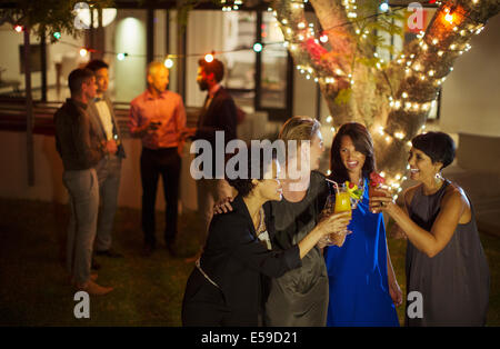 Friends toasting each other at party Banque D'Images