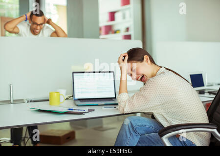 Woman working at laptop in office Banque D'Images