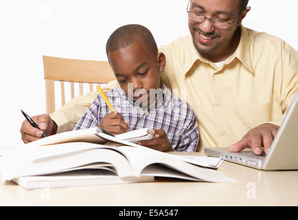African American father helping son with Homework Banque D'Images