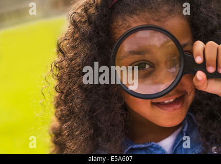 Mixed Race girl à l'aide de loupe Banque D'Images