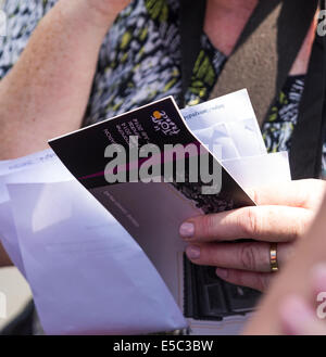 Paris, France. 27 juillet, 2014. Femme tenant dans ses mains invitation billets pour le Tour de France. Le dimanche 27 juillet 2014 les champs Elisées et Rue de Rivoli ont été fermées à la circulation en raison de l'arrivée du Tour de France. Partisans attendaient depuis tôt le matin pour avoir la meilleure place pour voir l'arrivée des athlètes. Les spectateurs ont connu, parfois quelques difficultés pour obtenir leur place parce que des barricades. Credit : Cecilia Colussi/Alamy Live News Banque D'Images