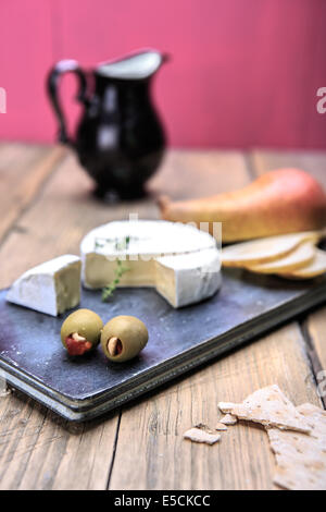 Nature morte avec assiette de fromage et les olives sur la table Banque D'Images