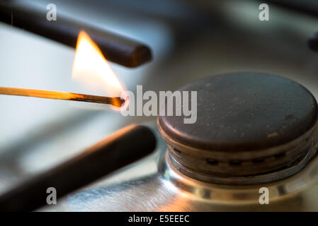 Match allumé le brûleur à gaz dans la cuisine Banque D'Images