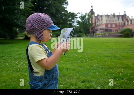 Deux ans garçon avec une carte. Banque D'Images