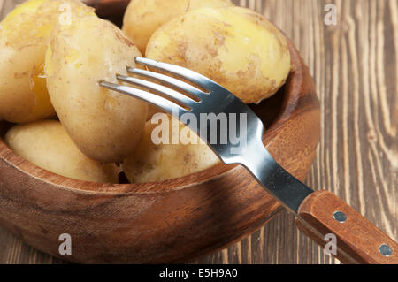 Les jeunes durs les pommes de terre dans un bol en bois Banque D'Images