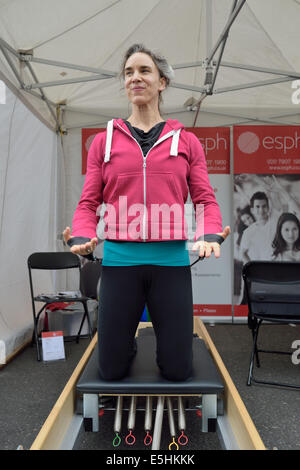 Une femme séduisante démontrant la formation de force de remise en forme à Marylebone Summer Fayre festival juste parti, Londres, Royaume-Uni. Banque D'Images