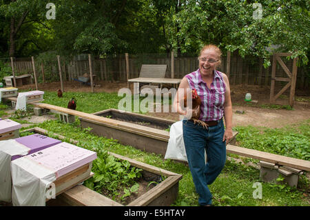 Meme Thomas porte l'une de ses poules dans son jardin 18 juin 2014 à Baltimore, Maryland (États-Unis Air Force photo/Le s.. Eli Banque D'Images